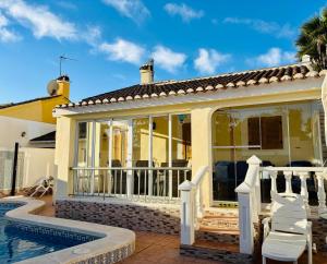 a villa with a pool and a house at Villa Limon Playa Flamenca in Alicante