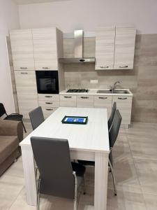 a kitchen with a table with a tablet on it at Station's Room in Avellino
