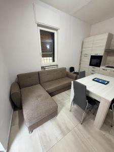 a living room with a couch and a table at Station's Room in Avellino