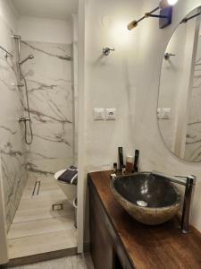 a bathroom with a sink and a mirror at Archontiko Hotel in Kalymnos