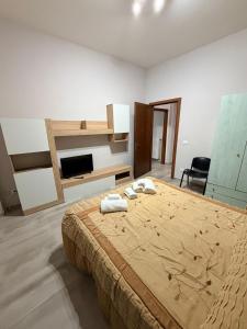 a bedroom with a bed with two towels on it at Station's Room in Avellino