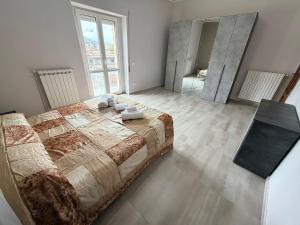 a bedroom with a large bed and a large mirror at Station's Room in Avellino