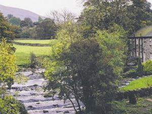a painting of a stone path in a garden at 2 Farfield Cottages in Sedbergh