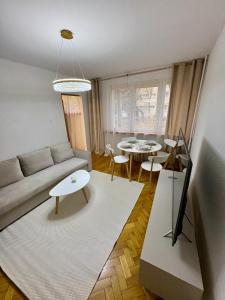 a living room with a couch and two tables at MW Leo Apartament in Konin