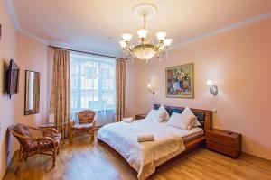 a bedroom with a large bed and a large window at Avrora Spa Hotel in Stepan'kovo