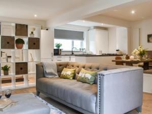 a living room with a couch and a kitchen at Dales Retreat in Skipton