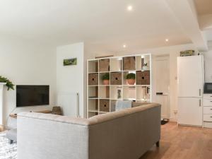 a living room with a couch and a refrigerator at Dales Retreat in Skipton