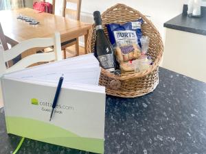 a basket of bread and a knife on a table at Wye Lodge in Aberedw