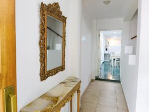 a mirror on a wall next to a hallway at Amplio departamento en pleno centro con cochera privada in San Rafael +13 photos
