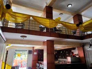 a bar with yellow drapes hanging from the ceiling at South gate hotel in Addis Ababa