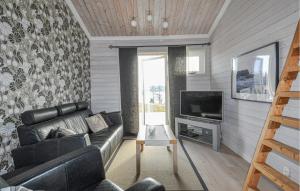 a living room with a couch and a television at 3 Bedroom Beautiful Home In Årjäng in Årjäng