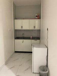 a kitchen with white cabinets and a sink at شقق المصيف الفندقيه in Hafr Al Baten