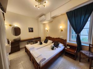 Postel nebo postele na pokoji v ubytování Archontiko Hotel + 87 fotografií