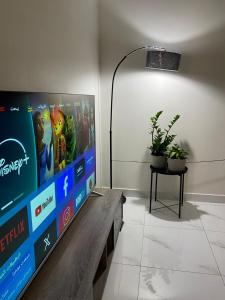 a living room with a large screen tv on a table at شقق المصيف الفندقيه in Hafr Al Baten +5 photos