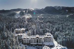 an aerial view of a resort with snow covered trees at Charming Apartment Borovets Gardens D16 in Samokov