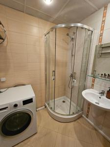 a washing machine in a bathroom with a shower at Charming Apartment Borovets Gardens D16 in Samokov