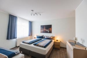 a bedroom with two beds and a window at Inselglück App 1 in Norderney