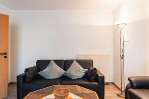 a living room with a couch and a table at Inselglück App 1 in Norderney