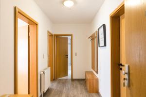 a hallway with an open door and a room with a hallway at Mayglück App 1 in Norderney