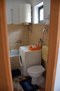 a bathroom with a toilet and a sink and a tub at Monika in Široki Brijeg