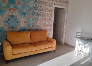 a living room with a couch and a table at Casa Via Marconi in Assemini +1 photo