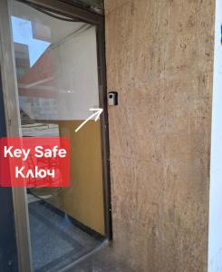 a sign on the door of a key safe window at 3 Rooms Apartment, Top Center, 1st Floor Flat, AUBG, WiFi, PC i5 SSD, Tablet, AndroidMiTvBox, 3 LED TVs 200 Channels, Long Terrace, Self-Easy-Late Check-in, Stay Before Greece in Blagoevgrad +85 photos