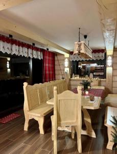 a dining room with a table and a table and chairs at Świstakówka in Szczyrk