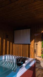 a swimming pool in a house with a window at Magiczny Widok Tiny House in Jurków