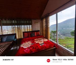 a bedroom with a bed and a large window at Malsha Bunglow in Nuwara Eliya