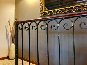 a wrought iron fence with a mirror on the wall at Allegretto Rialto in Venice +37 photos