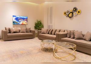 a living room with two couches and a table at Naseem Sur 