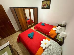 une chambre avec deux lits et un miroir dans l'établissement La casa di Nonna nel Piazzalino Asciano Siena Crete Senesi, à Asciano