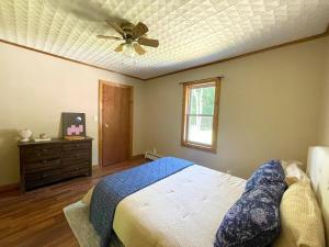 a bedroom with a bed and a ceiling fan at Cozy Creek House in Forestburgh