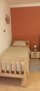 Ένα ή περισσότερα κρεβάτια σε δωμάτιο στο Apartman Tina