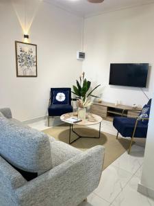 a living room with a couch and a tv at Coastal Blue Apt 7 in Flic-en-Flac