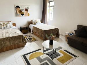 a living room with two beds and a couch at Coastal Blue Apt 7 in Flic-en-Flac +20 photos