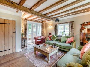 a living room with two couches and a table at Hill Farm in Blyford