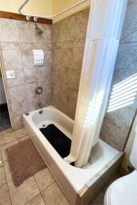 a bath tub with a shower curtain in a bathroom at The Cottage in Panguitch +22 photos
