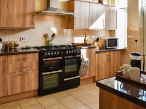 a kitchen with a black stove top oven at St Judes in Mundesley