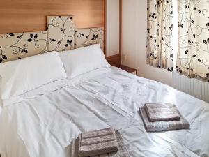 Ένα ή περισσότερα κρεβάτια σε δωμάτιο στο Inglenook Lodge