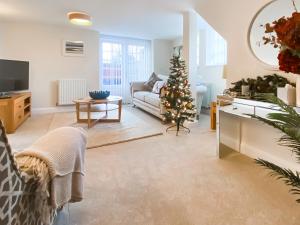 een woonkamer met een kerstboom en een bank bij The Police Station - Uk45642 in Silloth