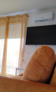 a living room with a couch and a television at Casa Via Marconi in Assemini