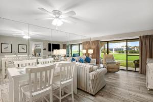a dining room and living room with a ceiling fan at Mermaid's Den in Panama City Beach