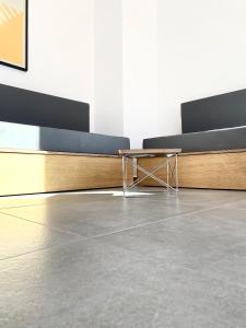 a room with benches and a table in a room at Lefko Apartments in Tavronitis