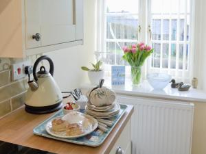 a kitchen counter with a tea kettle and plates on it at Gwel An Porth in Charlestown