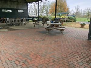 a patio with a picnic table and a playground at Swan in Welney