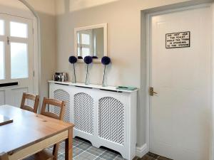 a dining room with a table and a mirror at Station House in Hornsea