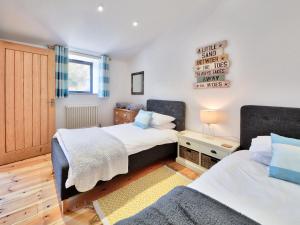 a bedroom with two beds and a sign on the wall at Dornfelder - Ukc3209 in Newbridge