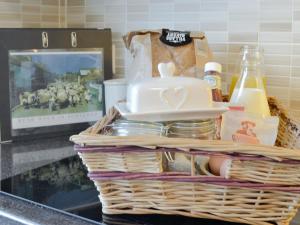 a basket on a counter with food and a television at Drumwherry By The Sea in Monreith