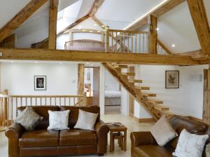 a living room with a couch and a staircase at Coombe View in South Redworthy